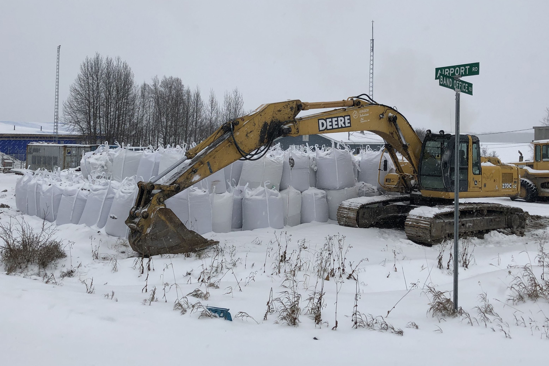 Machines Moving Sandbags for Flooding Image